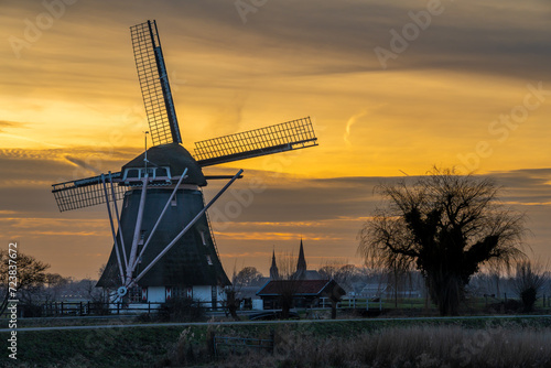 Abcoude, The Netherlands. Typical dutch landscape with traditional windmill by sunset