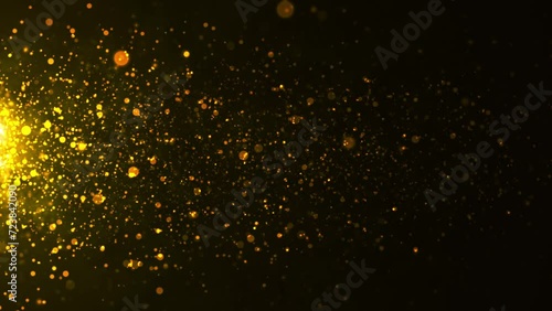 gold particles with lens flare on black background