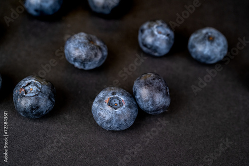 Close up view of fresh blueberries  on a dark background. Concept for elegant presentation of healthy food..