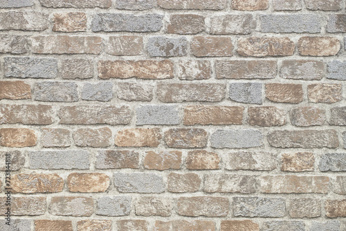 pattern of decorative stone wall background. Close-up modern beige stone tile texture brick wall