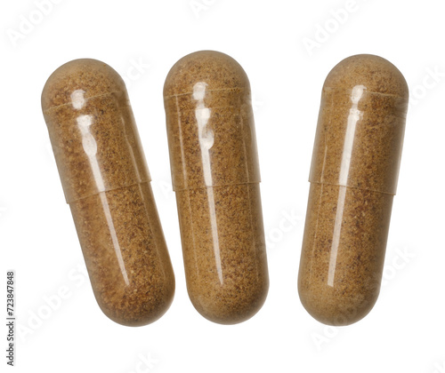 Photography Transparent capsule with brown powder on isolated background, medical drug