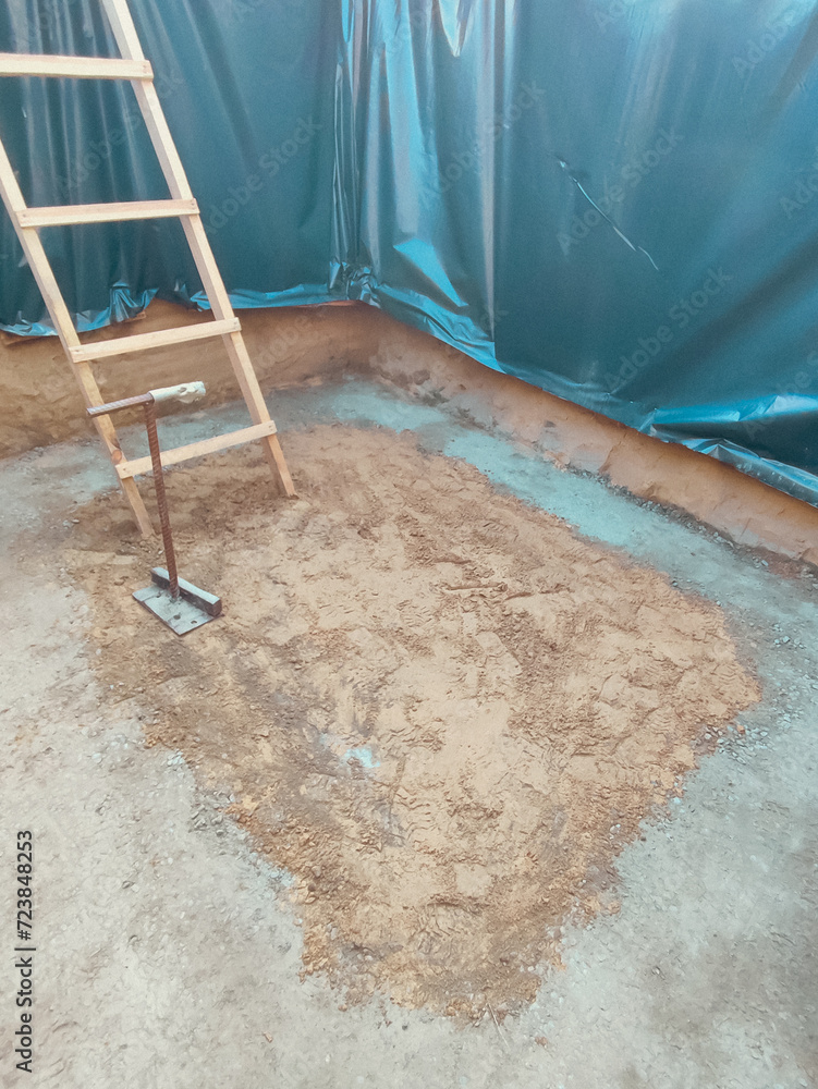 Manual compaction of soil, compaction of soil in a pit for the ...