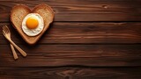 Heart shaped bread slice with sunny side up egg, top view  copy space for text placement