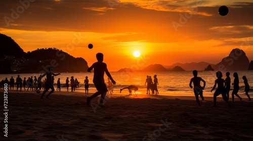 Silhouettes of many children playing beach soccer on the seashore at sunset. Summer vacation  holiday  summer sport  active lifestyle.