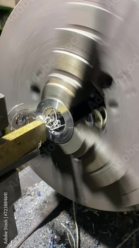 Vertical screen: Machining shaft on lathe. metalworking. Turner working on machine. Lathe work. metalworking. Cutting metal modern processing technology. CNC Milling Machine Produces