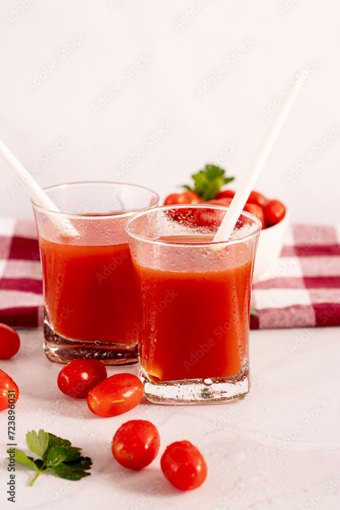 Tomato juice in a glass and fresh tomatoes. on a white background. food Tomato juice in a glass and fresh tomatoes. on a white background. food