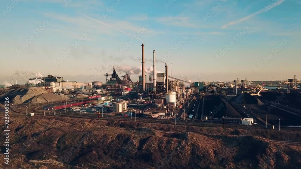 Industrial Impression: Aerial View of Steel Factory in the Netherlands with polluted Smoke Industrial Impression: Aerial View of Steel Factory in the Netherlands with polluted Smoke