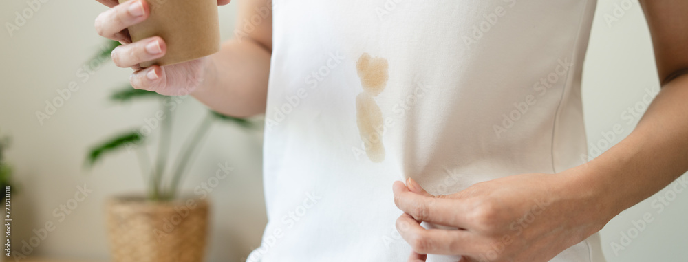 Obraz premium Clothes stain dirty from food concept, people get a coffee drop split from glass on the t-shirt.