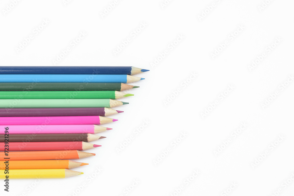 Seamless wooden coloured pencils in a row and arranged in a diagonal line, isolated on white background, copy space Seamless wooden coloured pencils in a row and arranged in a diagonal line, isolated on white background, copy space