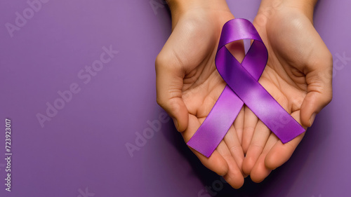 Two hands holding awareness ribbon, purple background, top view, copy space on the left
