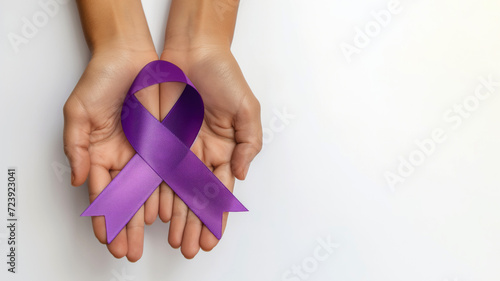 Two hands holding purple awareness ribbon, white background, top view, copy space on the right