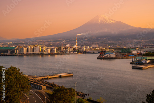 Japan industrial factory area with Fuji mountain and sun rise or sunset sky background view from Fishing port, Fujinomiya City, Shizuoka, Japan. photo