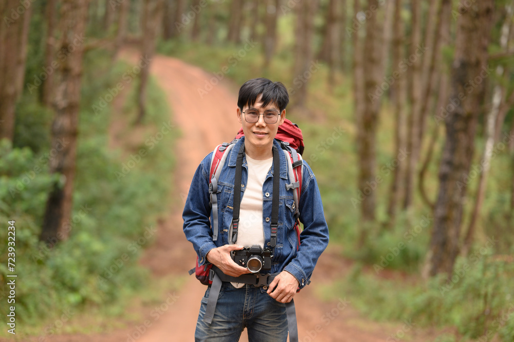 Backpacker carrying bags in forest and mountains Backpacker carrying bags in forest and mountains