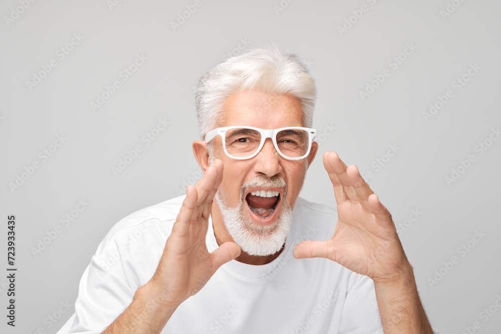Portrait of senior man in white shouting loudly with hands, news, palms folded like megaphone isolated on white background Portrait of senior man in white shouting loudly with hands, news, palms folded like megaphone isolated on white background