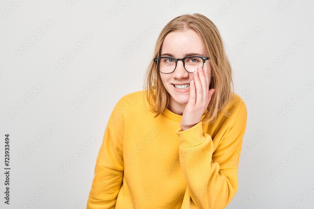 Portrait of young student girl shouting loudly with hands, news, palms folded like megaphone isolated on white background Portrait of young student girl shouting loudly with hands, news, palms folded like megaphone isolated on white background