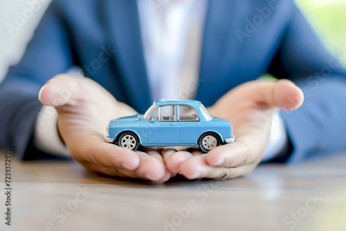 Minature car n businessman's hands. Insurance car ,Car loan