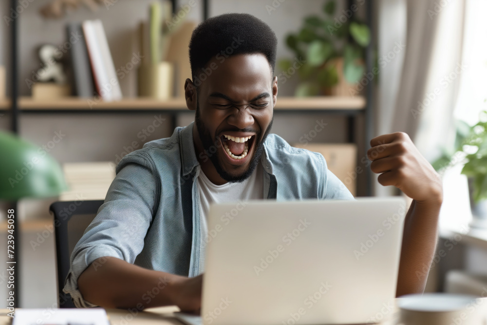 Excited young man looking at laptop screen. Handsome overjoyed guy feeling happy about his work. Excited young man looking at laptop screen. Handsome overjoyed guy feeling happy about his work.