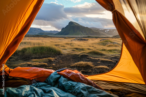 Beautiful sunrise view from the tent. Tourist admiring scenic morning landscape from inside the tent at campsite. Breathtaking Icelandic nature. Hiking by foot.