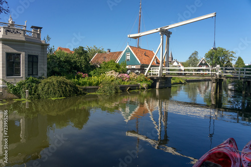 Kwakelbrug bridge in the beautiful city of Edam  Netherlands  with its typical houses and the church reflected on the canal  waterway .