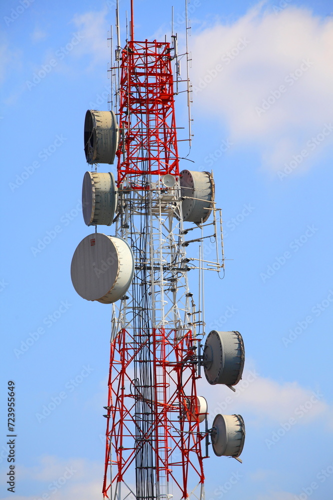 Telecommunications tower under a blue sky.