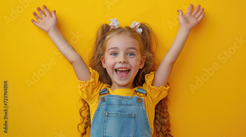 Portrait of young excited shocked crazy smiling girl child kid. isolated on yellow color background. photo