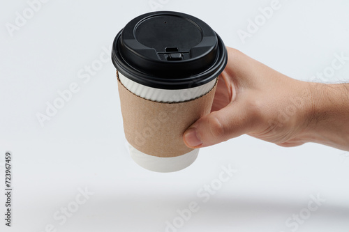 Hand hold paper cup with sleeve