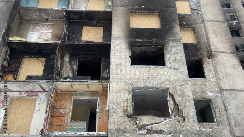 A damaged house in the city of Kyiv, Ukraine after a Russian missile attack. Burnt apartments, windows and doors, burnt wood. Burnt high-rise building. Consequences of war. High quality 4k footage A damaged house in the city of Kyiv, Ukraine after a Russian missile attack. Burnt apartments, windows and doors, burnt wood. Burnt high-rise building. Consequences of war. High quality 4k footage