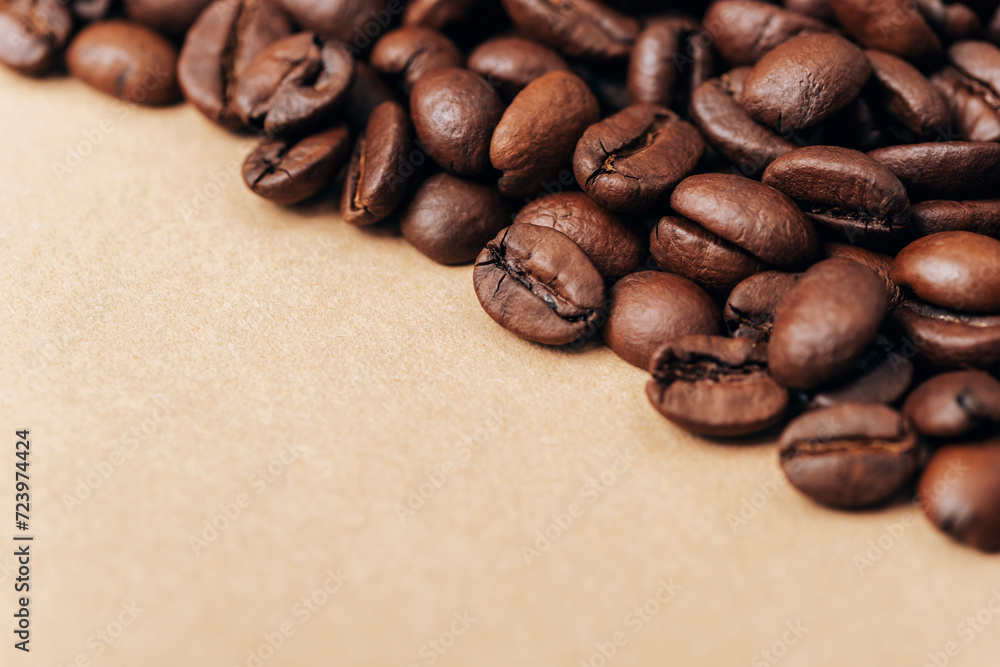 Roasted coffee beans on beige background. Closeup, copy space Roasted coffee beans on beige background. Closeup, copy space