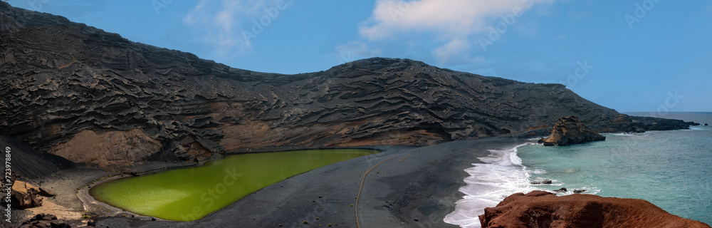 Stunning view of the imploded volcano caldera on the shores of the island of Lanzarote, Canary Islands. On the left the green lagoon at the center of the volcano Stunning view of the imploded volcano caldera on the shores of the island of Lanzarote, Canary Islands. On the left the green lagoon at the center of the volcano