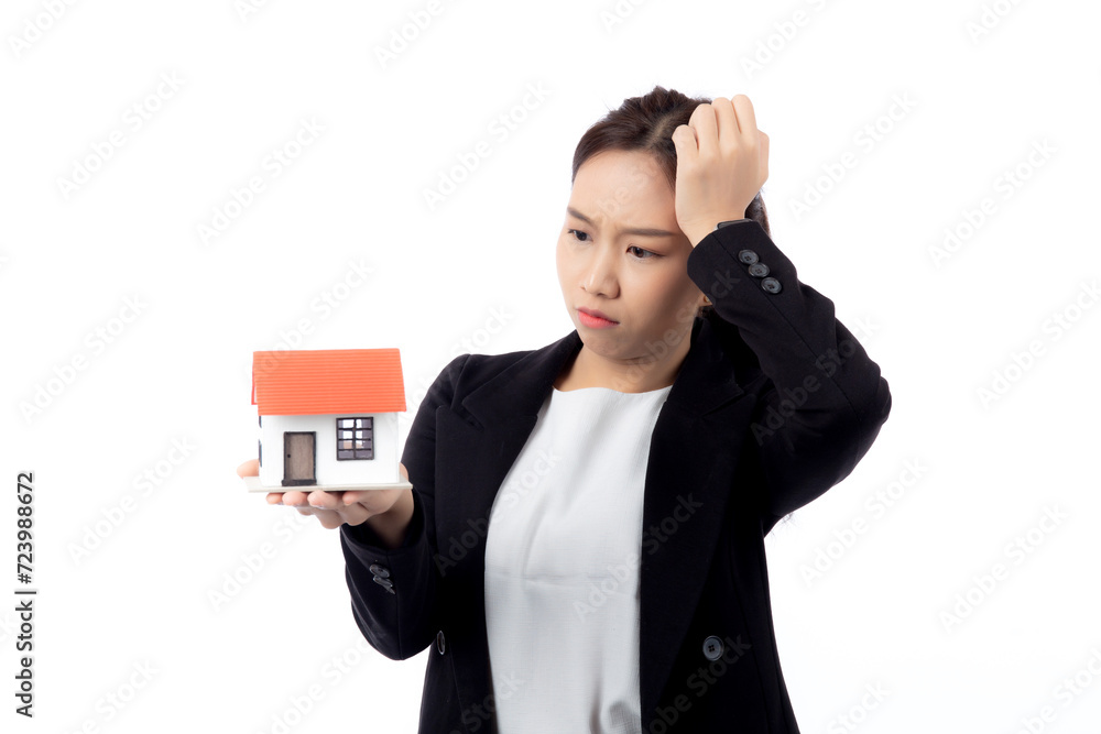 Portrait young asian businesswoman unhappy about loan of montage home isolated white background, expression and emotion, business woman annoyed and worried with debt house, stress and depressed. Portrait young asian businesswoman unhappy about loan of montage home isolated white background, expression and emotion, business woman annoyed and worried with debt house, stress and depressed.