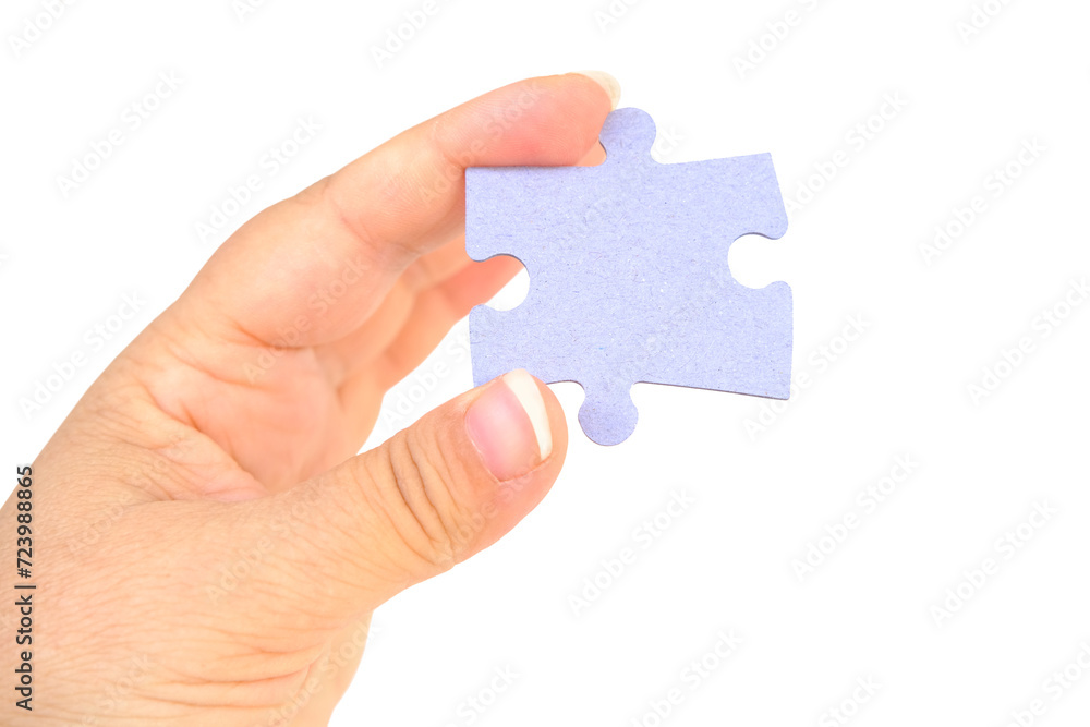 female hand holds cardboard puzzle piece, logical skills, puzzle solving and memory improvement, business concept for completing female hand holds cardboard puzzle piece, logical skills, puzzle solving and memory improvement, business concept for completing