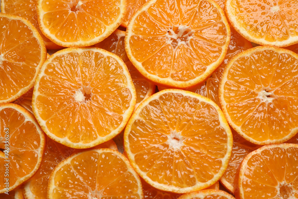 Slices of fresh ripe tangerines as background, top view. Citrus fruit Slices of fresh ripe tangerines as background, top view. Citrus fruit