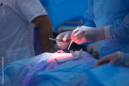 Surgery doctor sews up punctures in abdominal cavity with thread after using laparoscopic instrument, Closeup process