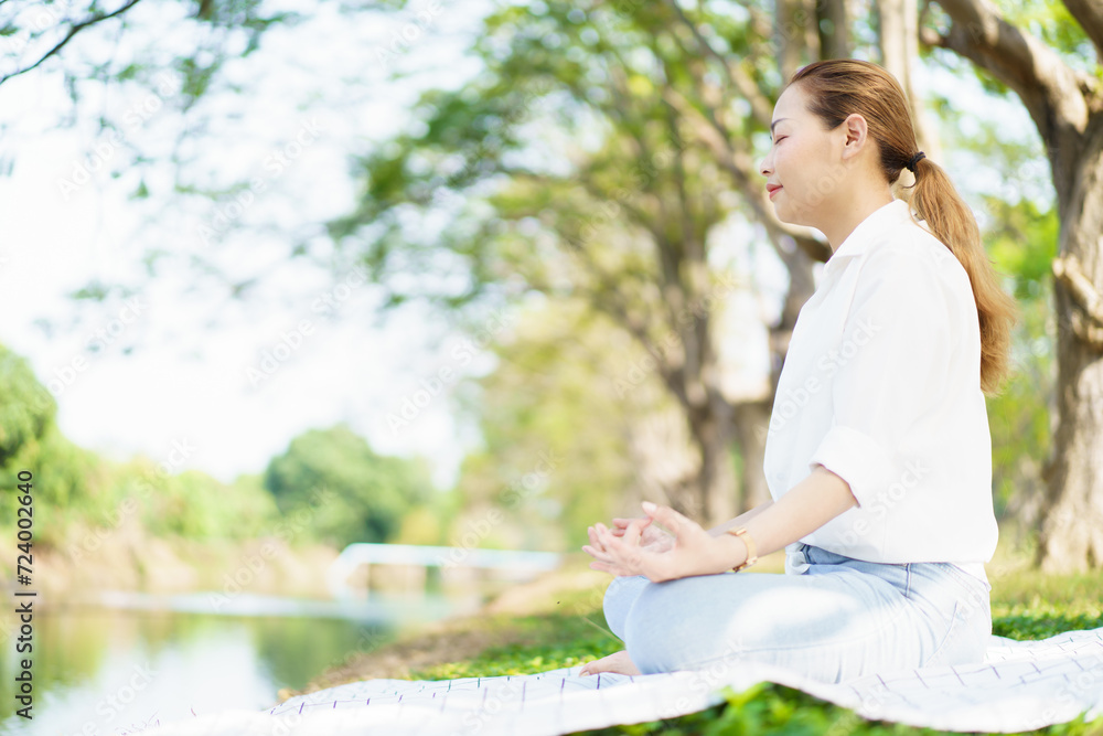 Happy Asian beautiful woman practicing yoga and meditation exercise in the morning.