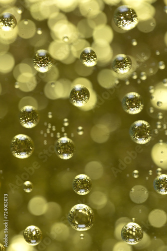 Golden bubbles against a gold bokeh background.
