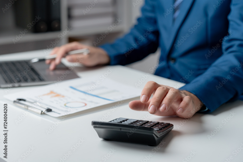 Financial Expert Analyzing Reports with Calculator. Financial Expert Analyzing Reports with Calculator.