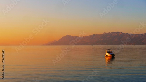 Boat in beautiful orange horizon in sunset