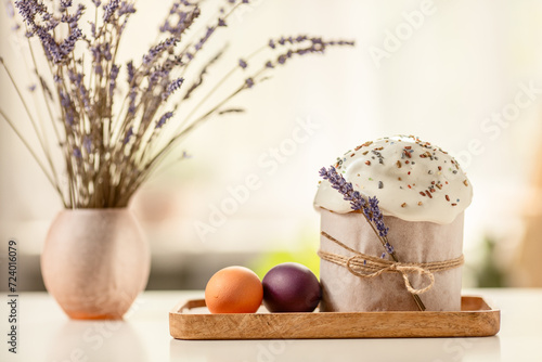 Traditional Orthodox Easter cake and colored eggs, on a white table in the middle plan on a light background. happy Easter
