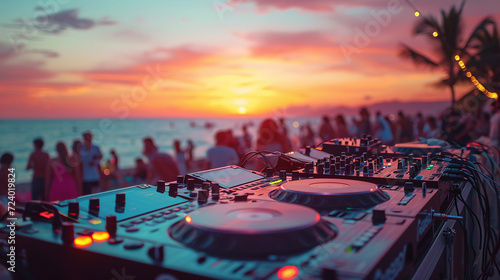 Fototapeta Naklejka Na Ścianę i Meble -  Beach party festival with dj mixing, Close up portrait of dj mixer table with beautiful evening sunset at tropical beach