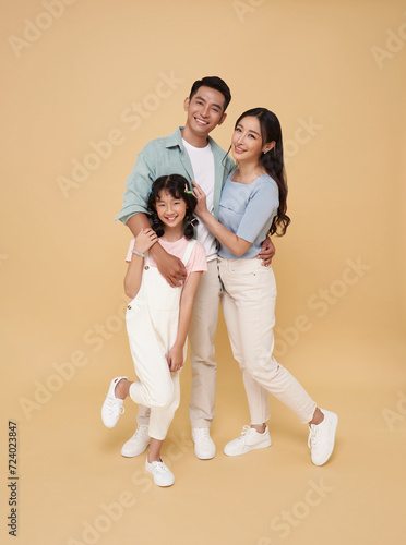 Portrait happy smiling Asian family hugging and love together isolated on nude color background.