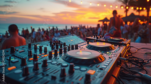 Beach party festival with dj mixing, Close up portrait of dj mixer table with beautiful evening sunset at tropical beach