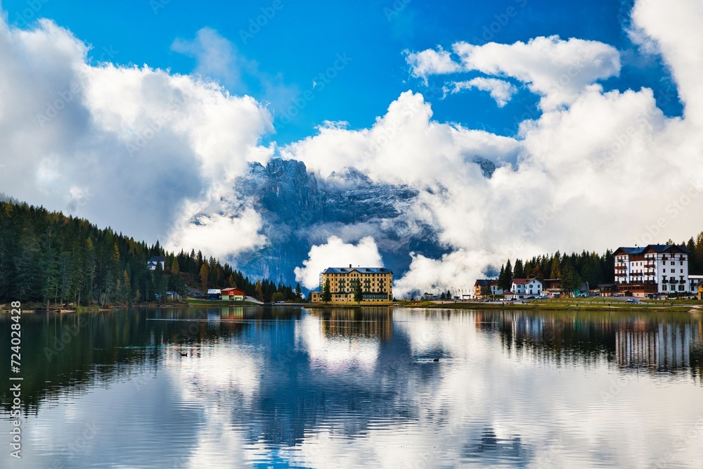 Fototapeta premium Dolomites Mountains and Lake Misurina in autumn season. Bright blue sky with clouds. Italy