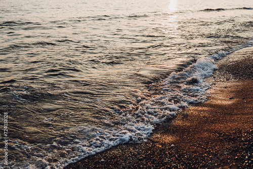 Fototapeta Naklejka Na Ścianę i Meble -  beautiful evening landscape on the sea. sunset of the setting sun. the sun disappeared behind the horizon of the sea.beautiful waves on the sandy beach