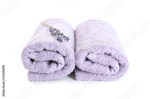 Rolled violet terry towels and dry lavender isolated on white