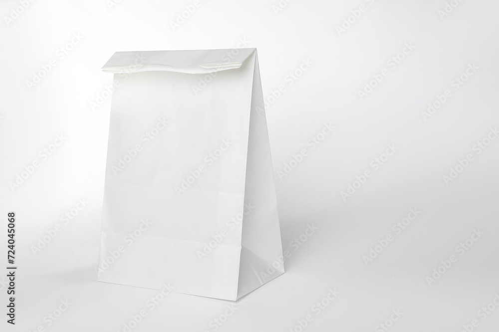 One paper bag on white background, space for text One paper bag on white background, space for text