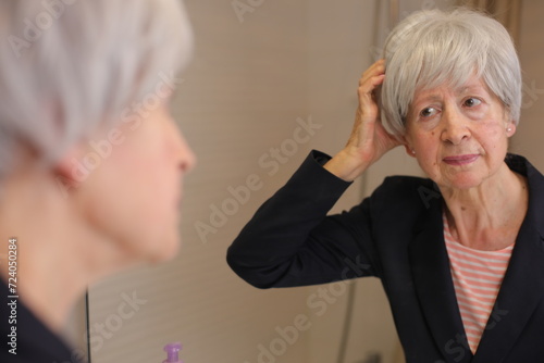 Senior woman with itchy scalp  photo