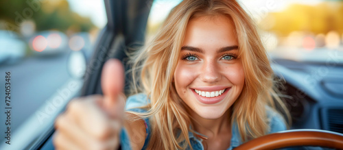 woman driving car, smiling, and with thumbs up
