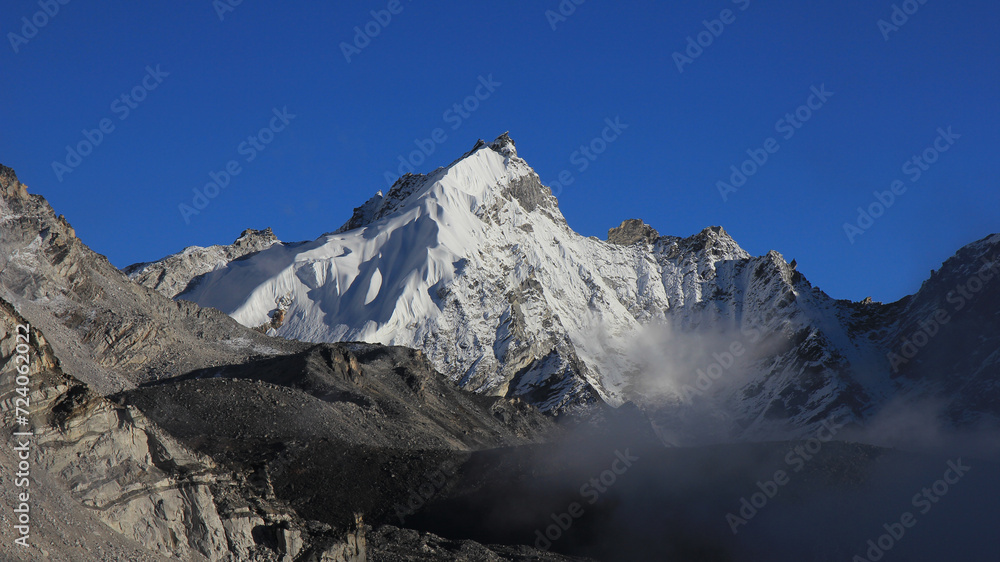 Blue sky over a high mountain. Late afternoon scene seen from Gorakshep, Nepal. Blue sky over a high mountain. Late afternoon scene seen from Gorakshep, Nepal.