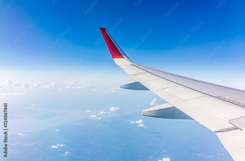 View from the airplane window at a beautiful cloudy sky and the airplane wing View from the airplane window at a beautiful cloudy sky and the airplane wing