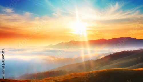 natural fog and mountains sunlight background blurring misty waves warm colors and bright sun light christmas background sky sunny color orange light patterns abstract flare evening on clouds blur